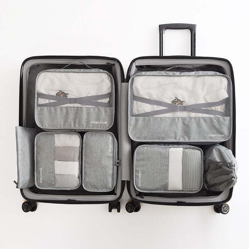Set of 7 waterproof travel tote bags in suitcase for organized packing.