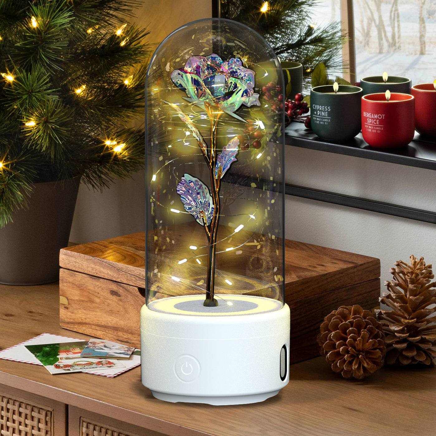 Creative 2 in 1 rose flower LED light and Bluetooth speaker under glass cover on wooden table with holiday decor
