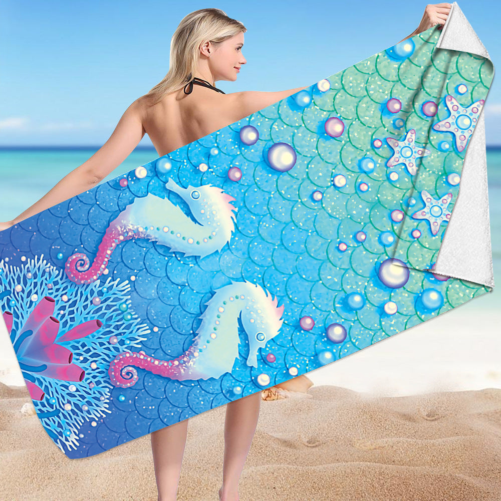 Microfiber bath towel with seahorse and starfish 3D print design on a beach.