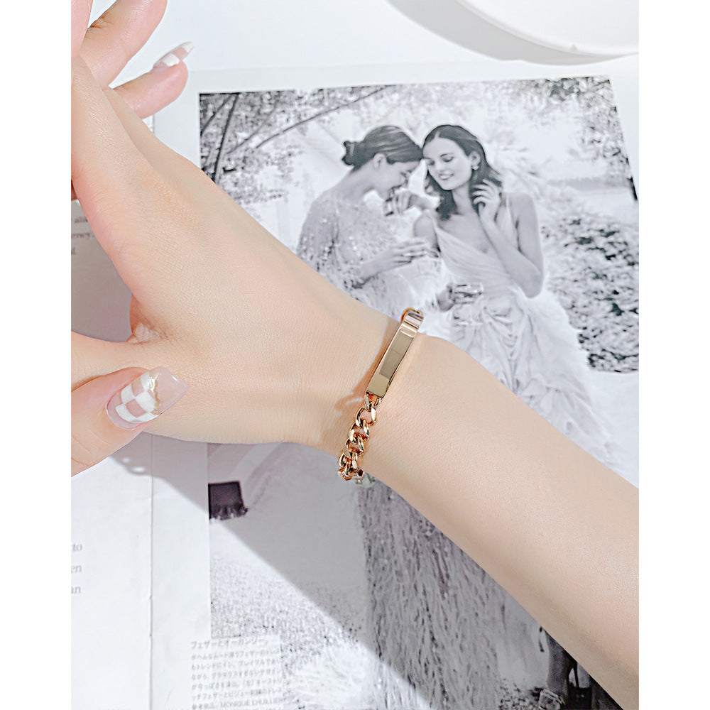 Titanium steel curved plate rose gold plated bracelet on wrist.