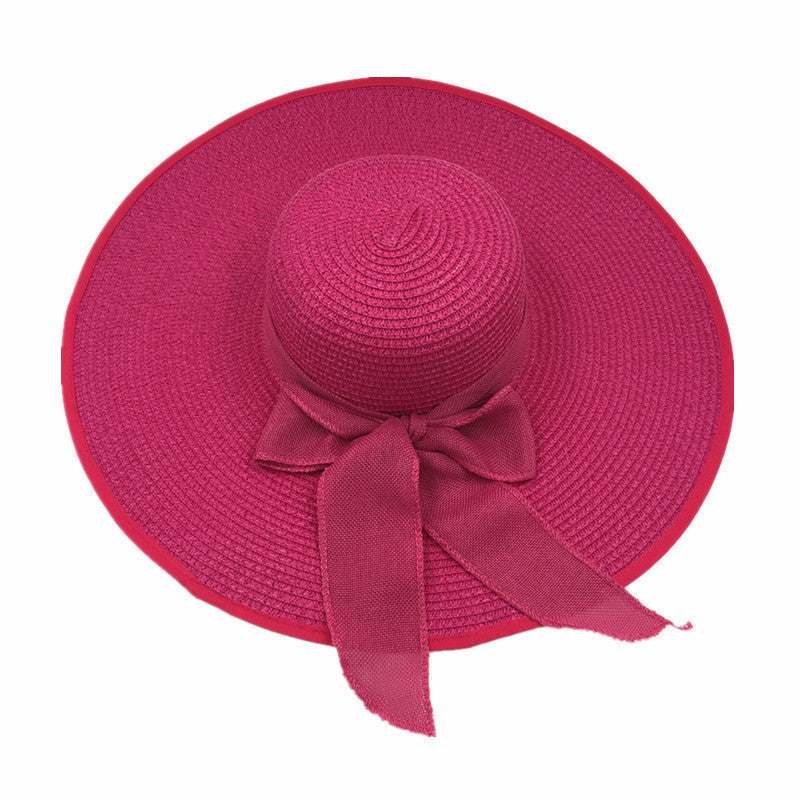 Ladies foldable straw hat with sun protection, big brim, pink color.