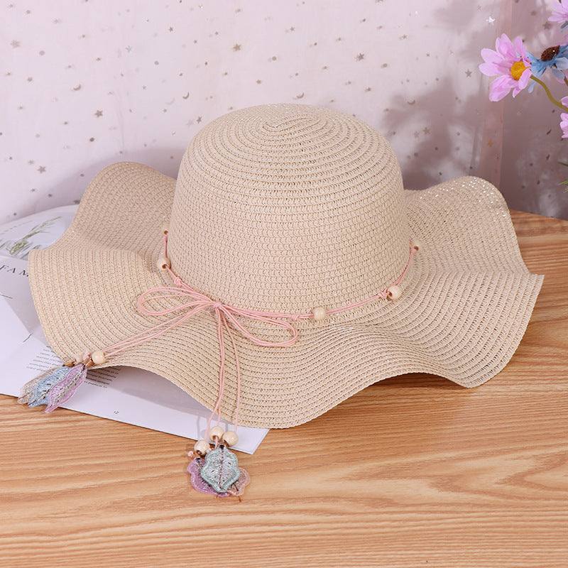 Ladies big brim wave straw hat with bow, perfect for outdoor shade.