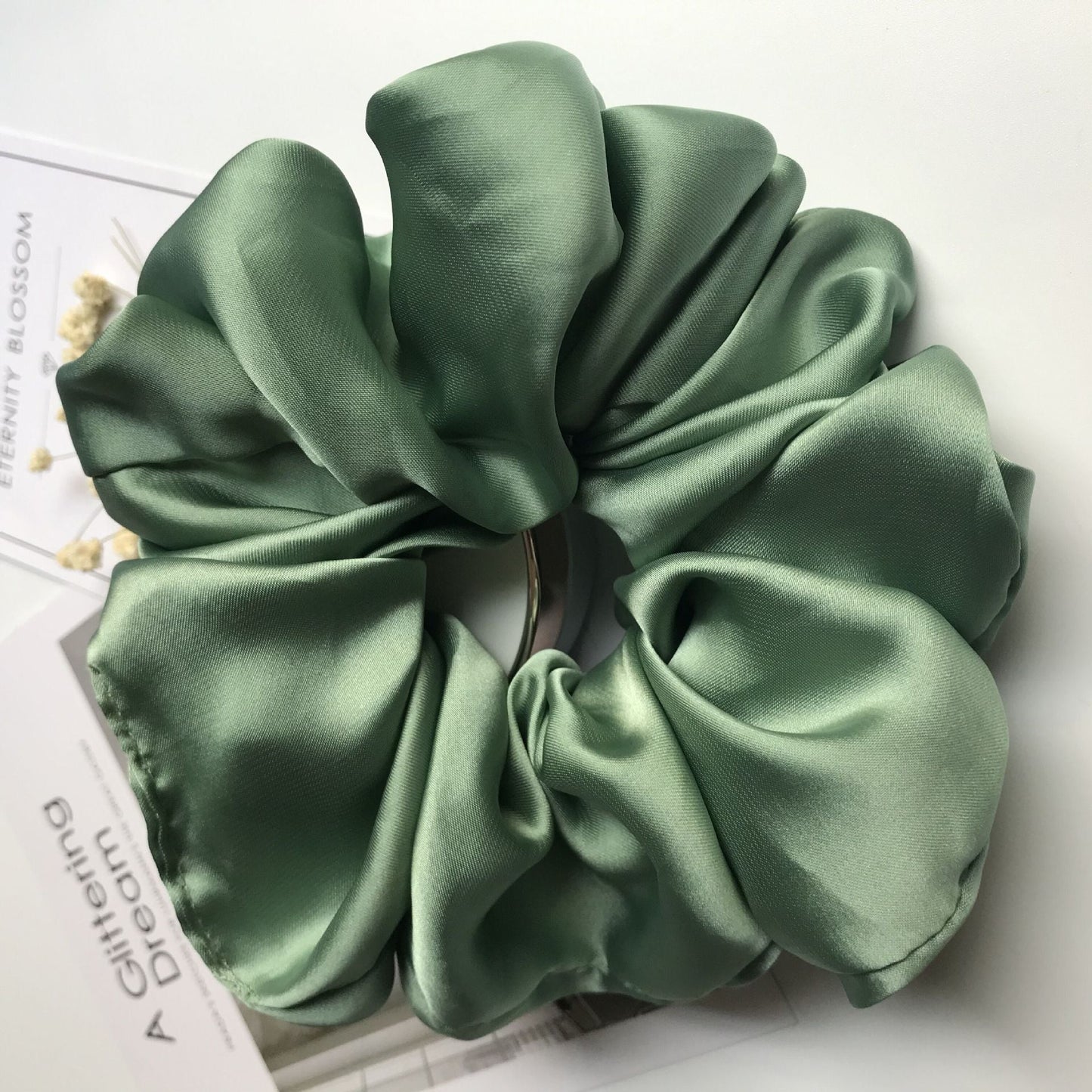 Oversized smooth satin large intestine circle hair tie in avocado green, handmade cloth material.