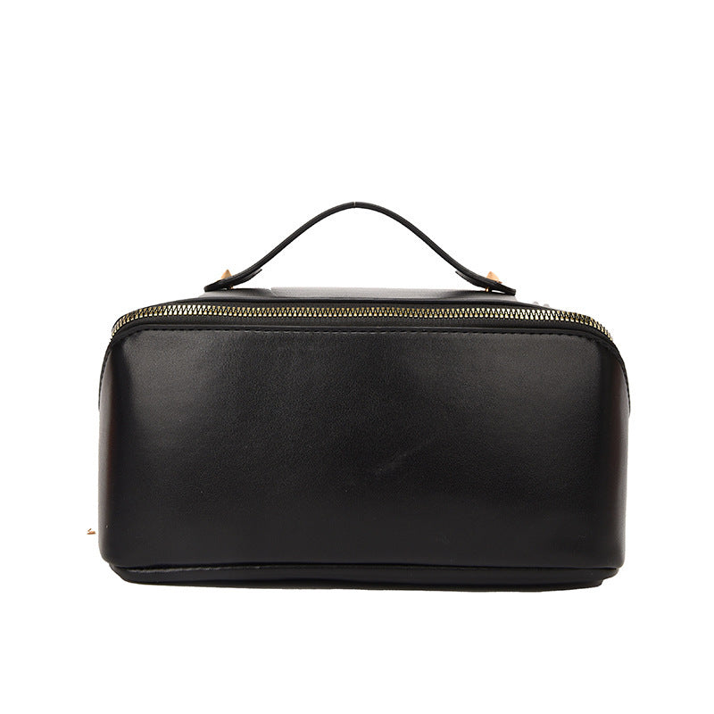 Black large capacity cosmetic bag for women, made of PU leather, with solid color and sewing line design.