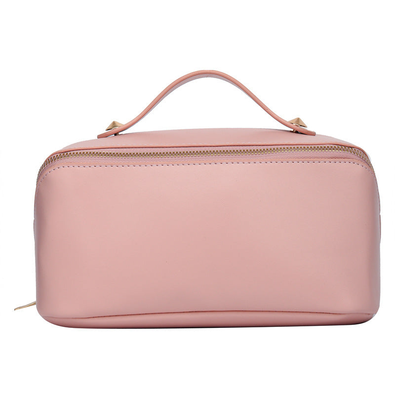 Pink PU leather large capacity cosmetic bag with handle for women.