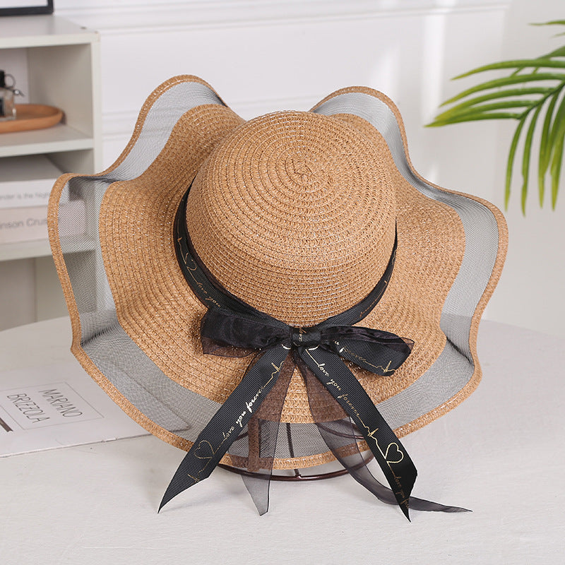 Elegant ladies mesh straw hat with big brim and streamers, ideal for sunshade and sunscreen.