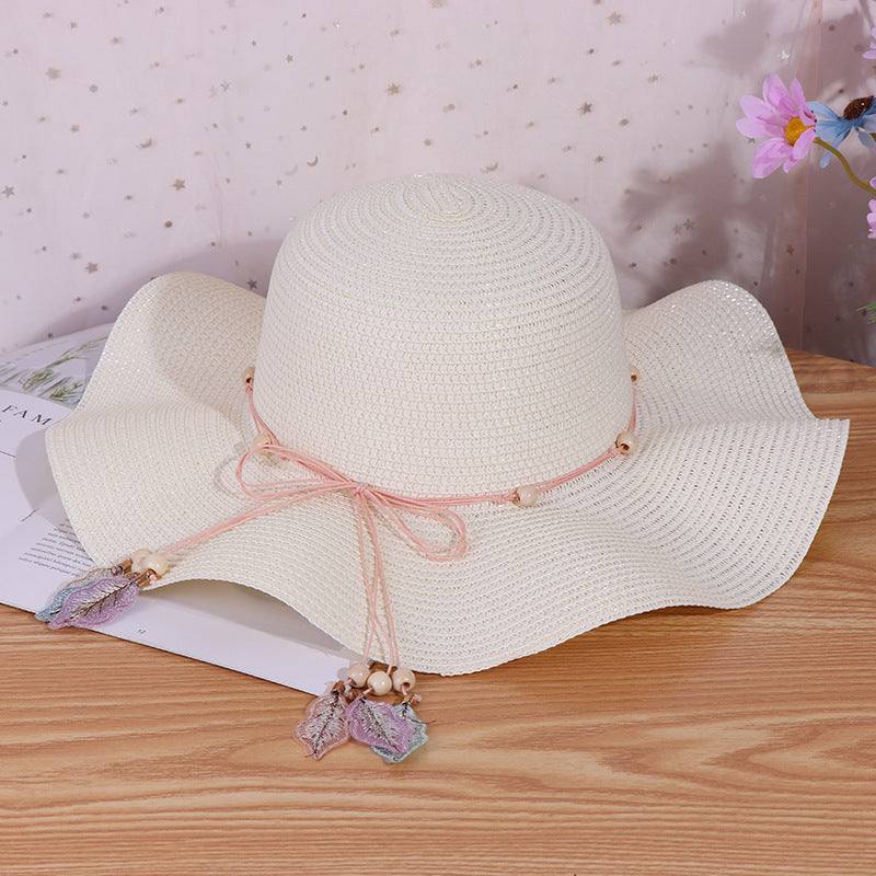 Ladies big brim straw hat with dome design and bow accents in milky white.