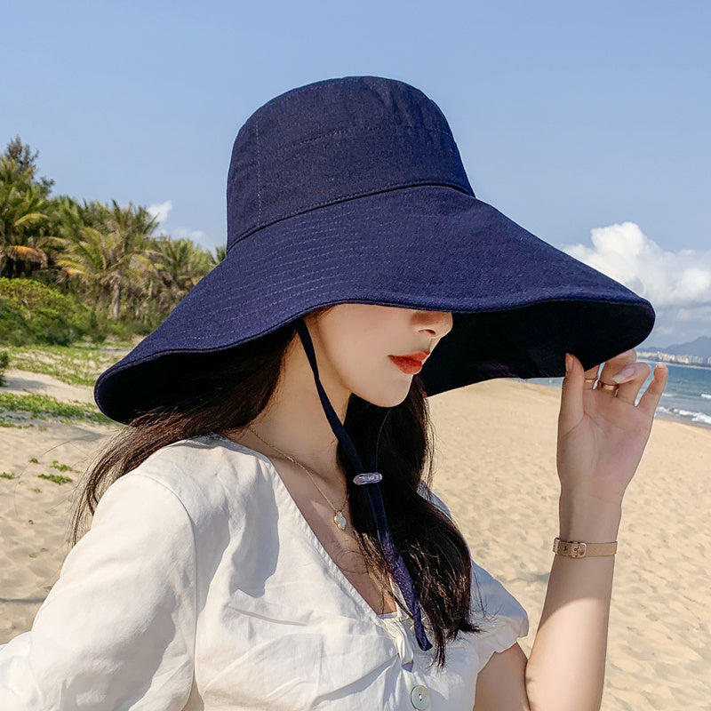 Japanese solid color big brim fisherman's hat in navy blue, ideal for women's spring and summer sun protection.