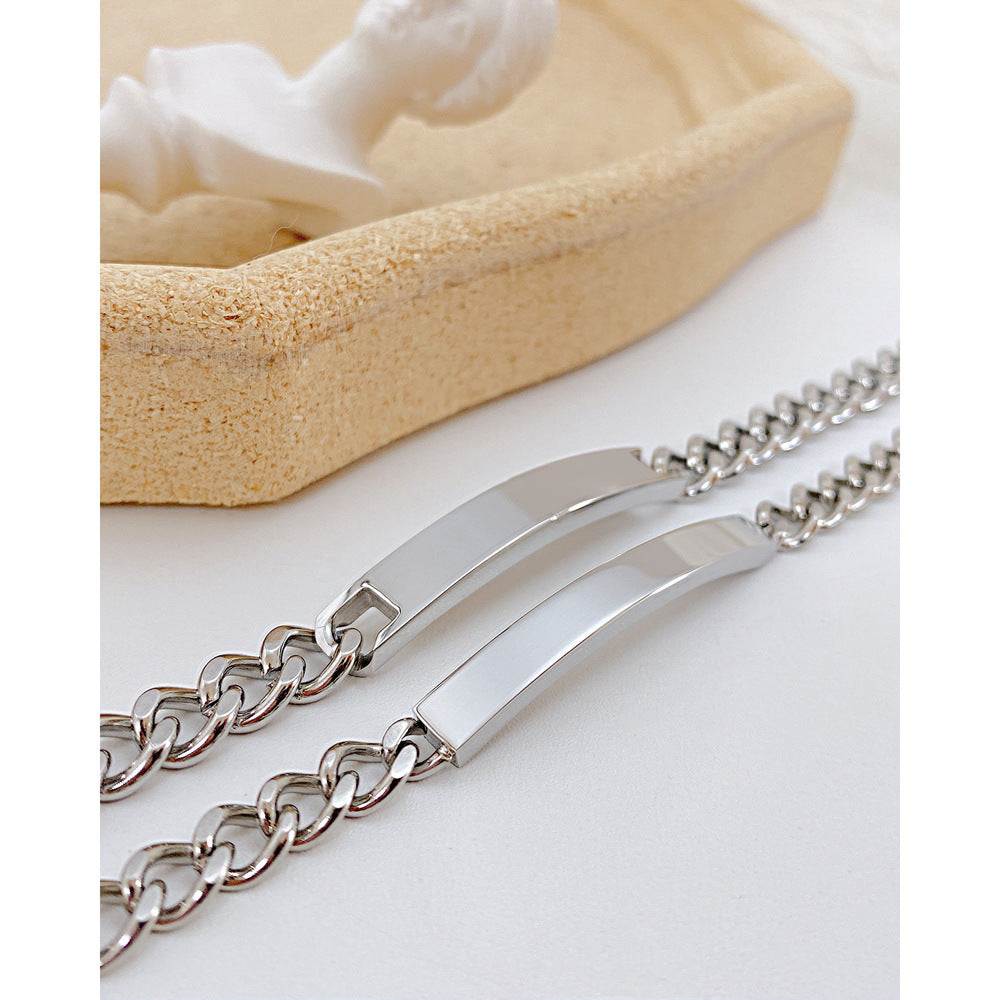 Titanium steel curved plate bracelet featuring a polished finish in silver, showcasing elegant design for men and women.