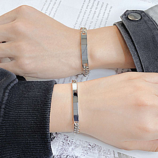 Titanium steel curved plate rose gold plated bracelet on wrists.