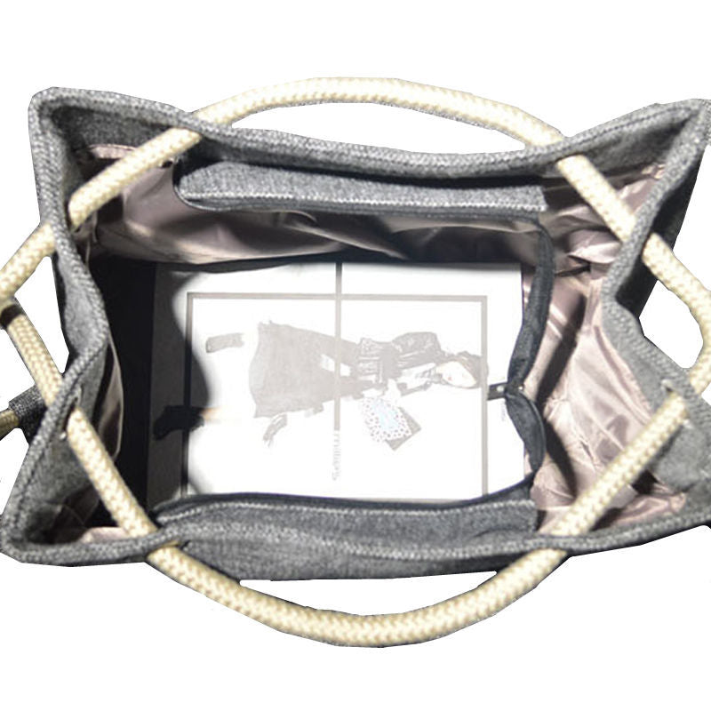 Inside view of a large capacity shoulder bag with soft handle and internal pockets.