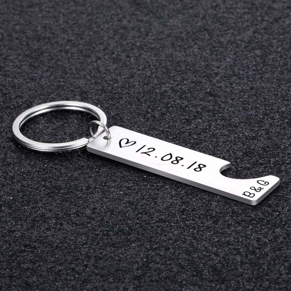 Customized couples keychain with engraved date, silver tone.