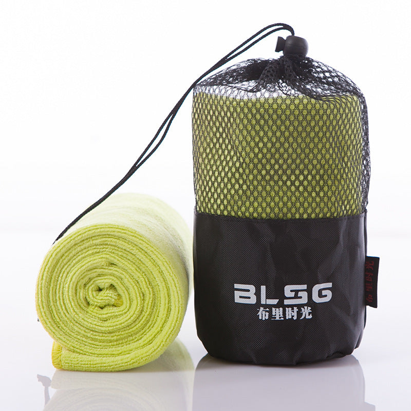Light green fitness sports towel in black mesh carrying bag, ideal for outdoor activities.
