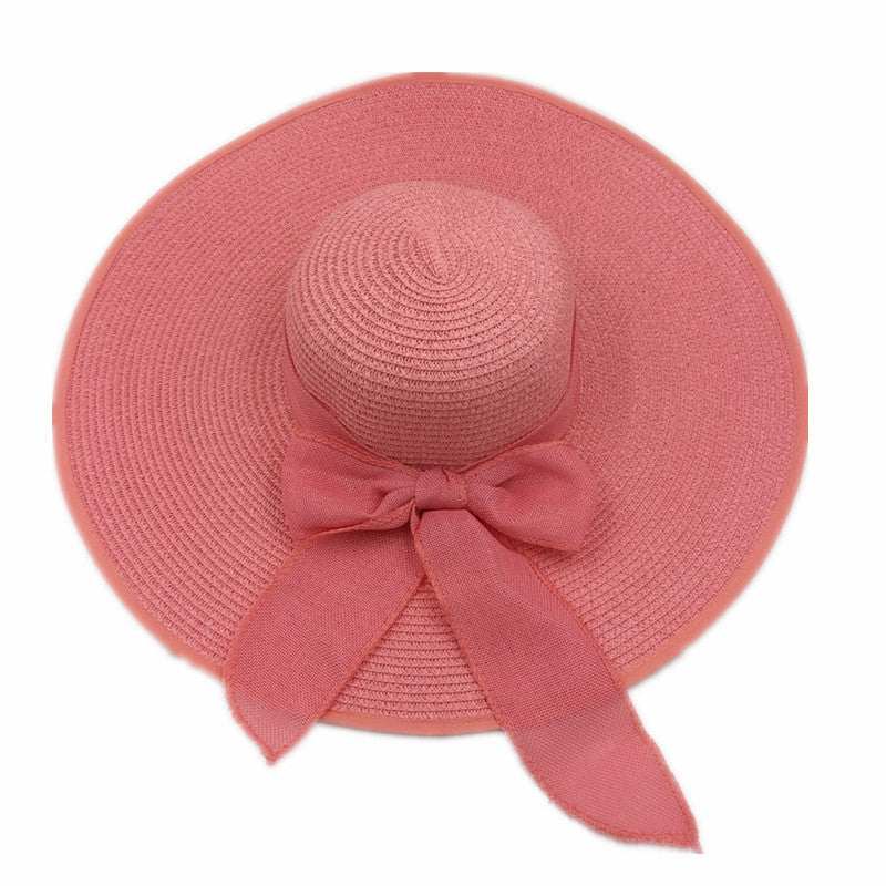 Pink foldable straw hat with big brim for sun protection, dome style, suitable for women.
