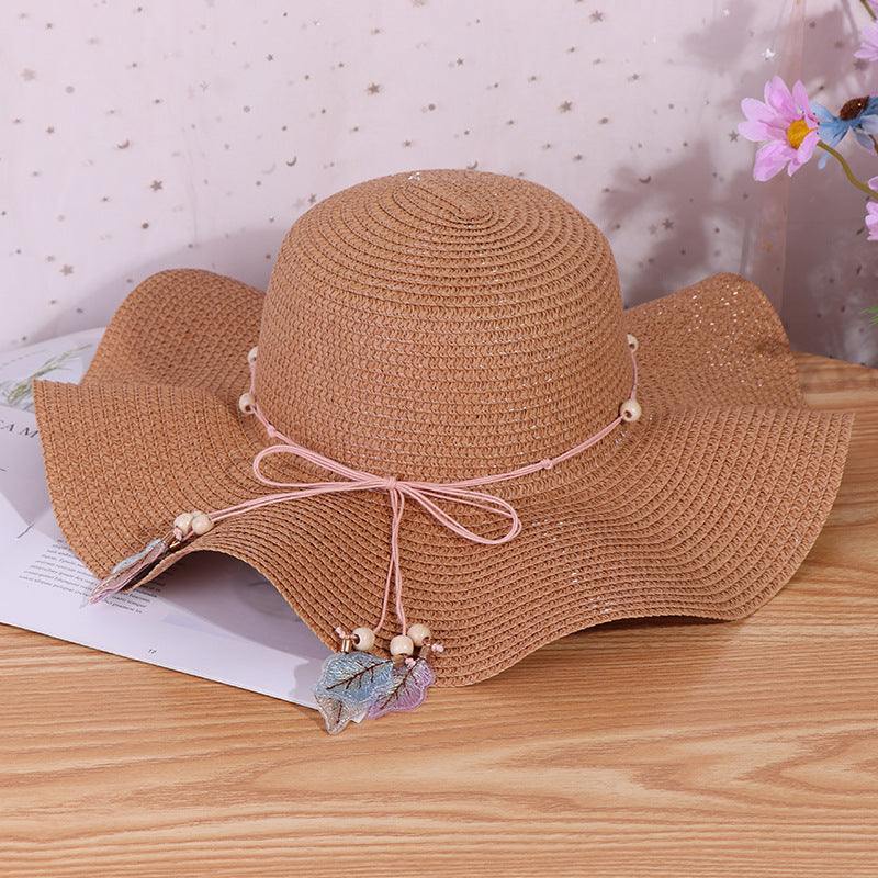 Ladies big brim wave straw hat with bow, dome style, suitable for outdoor shade.