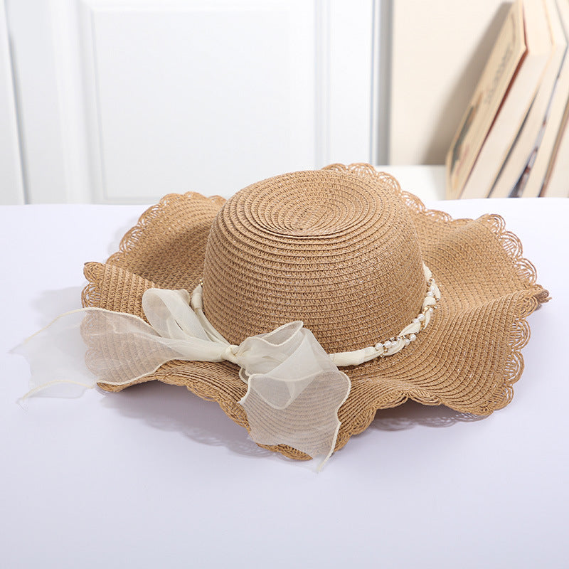 Big Eaves Beach Seaside Travel Sun Hat with Dome Style and Wide Brim in Beige Color with Ribbon and Pearl Chain.