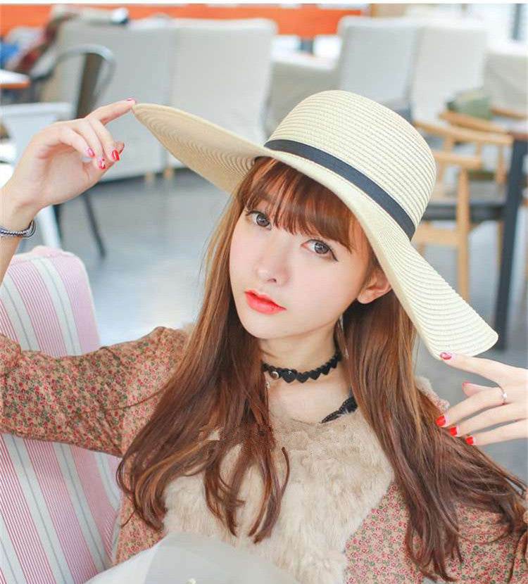 Women's straw woven big brim sun hat in beige with dome style.
