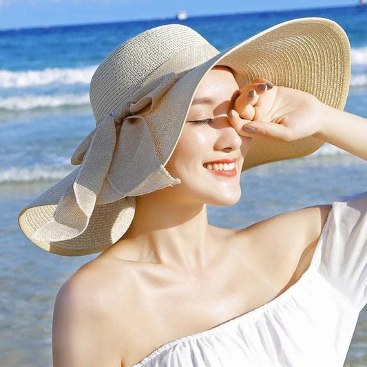 Ladies foldable straw sun hat with big brim for UV protection.