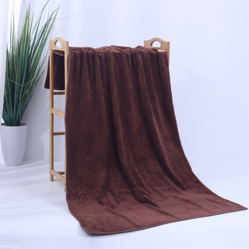 Microfiber thickened car wash cleaning towel in brown on a wooden rack.