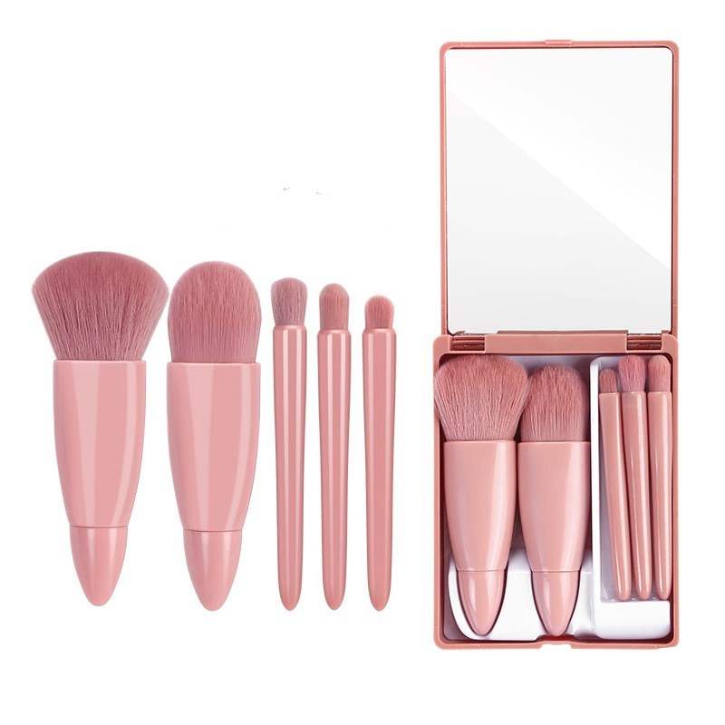 5-piece pink makeup brush set with mirror, featuring powder, blush, foundation, and eyeshadow brushes for precise application.