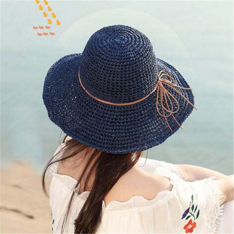 Foldable Raffia Women's Big Brim Beach Hat in navy with bow detail.