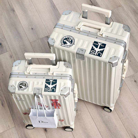 Durable aluminum frame luggage with stickers, universal wheels, and multiple functionalities.