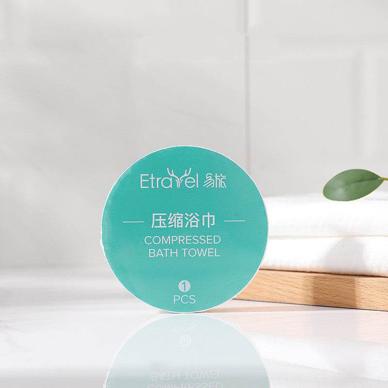 Disposable compression towel with packaging on a bathroom counter.
