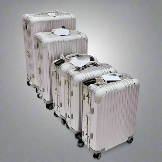 Large aluminum magnesium alloy luggage set in sleek silver finish with universal wheels.