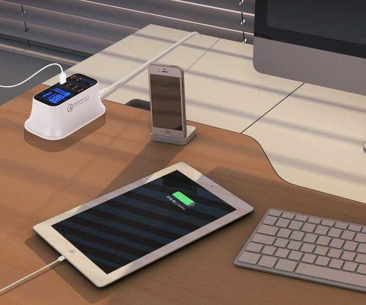 Quick Charge 3.0 USB charger station on desk charging multiple devices.