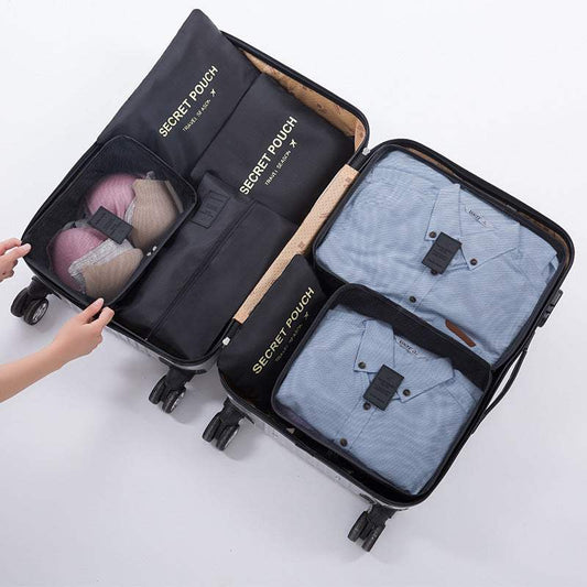 Travel luggage storage bag with organized compartments containing clothes and accessories in a suitcase.