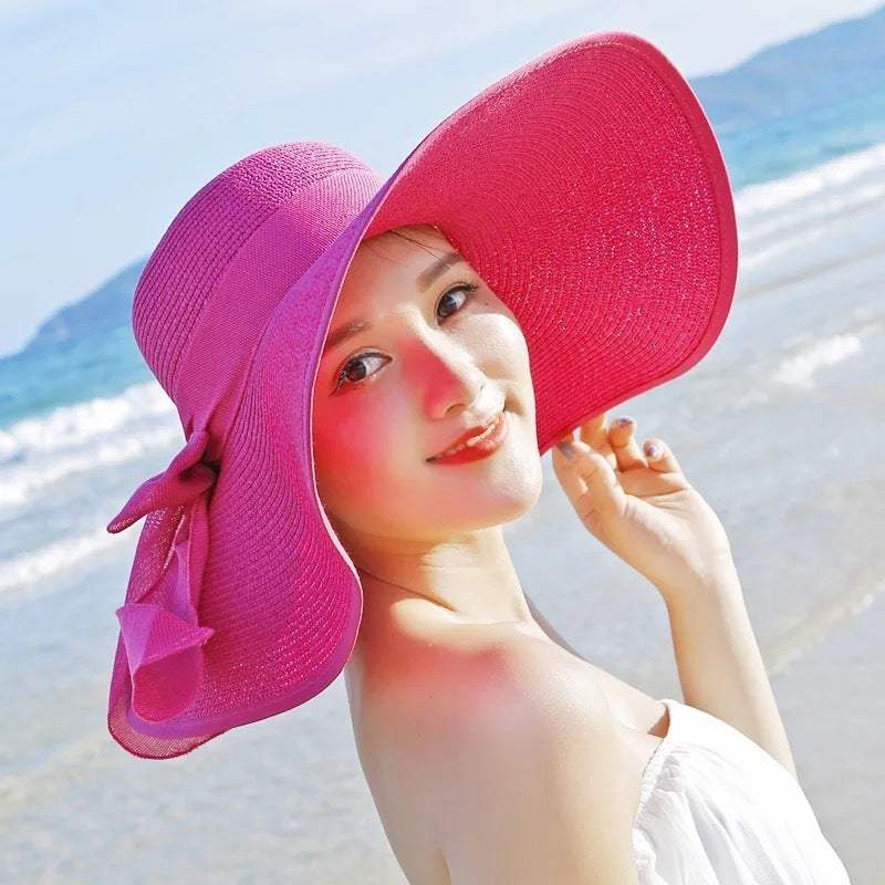 Ladies folding straw hat with big brim for sun protection at the beach.