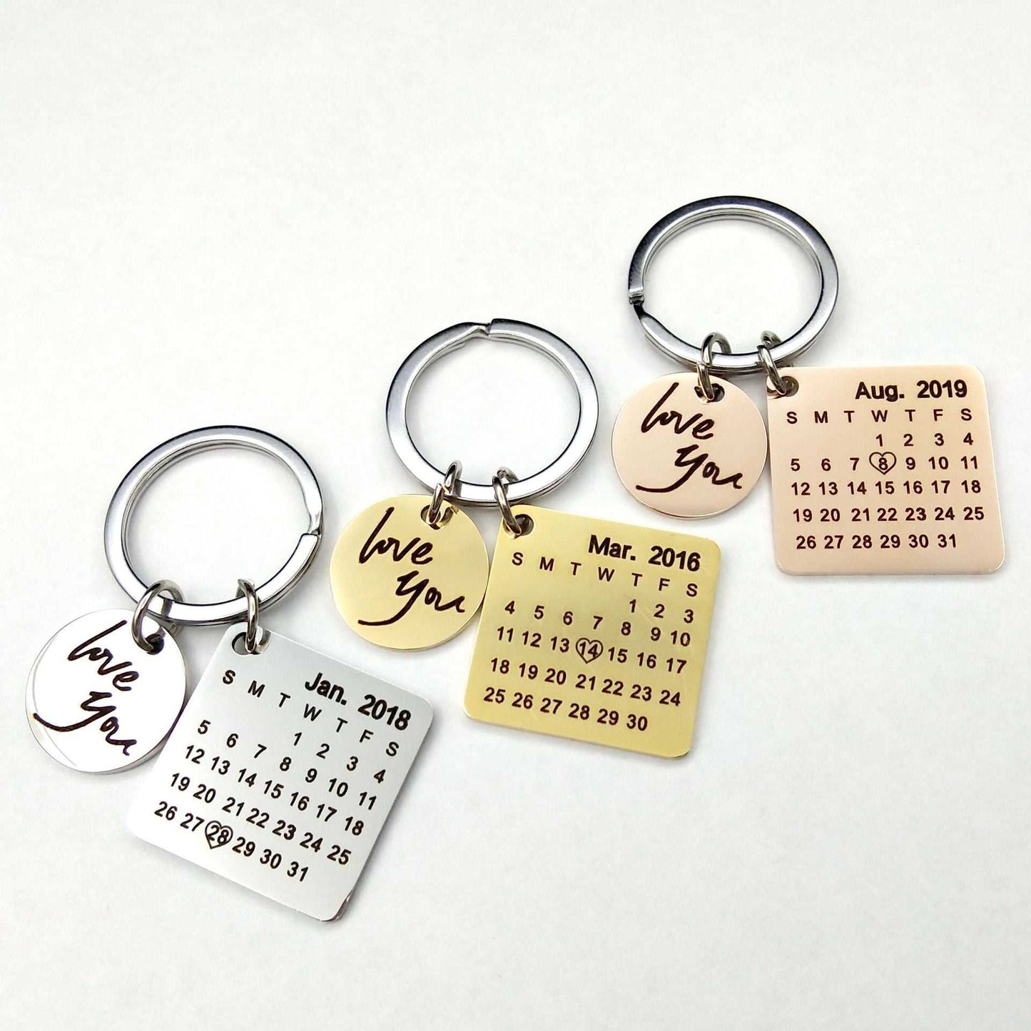 Custom DIY personalized calendar keychain with hand-carved dates, available in silver, gold, rose gold, and black; perfect gift for couples.