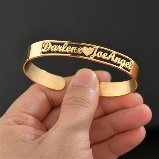 Customized gold name bracelet with engraved names, made of stainless steel.