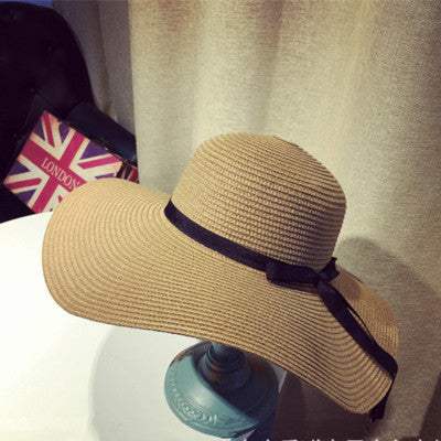 Women's straw woven big brim sun hat in khaki with a dome style.